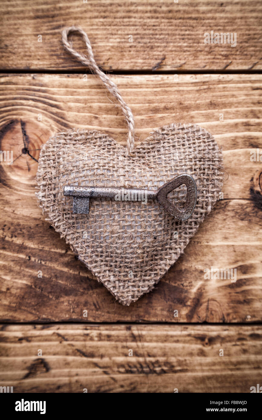 Love concept. An Old key and a heart on wooden background Stock Photo ...