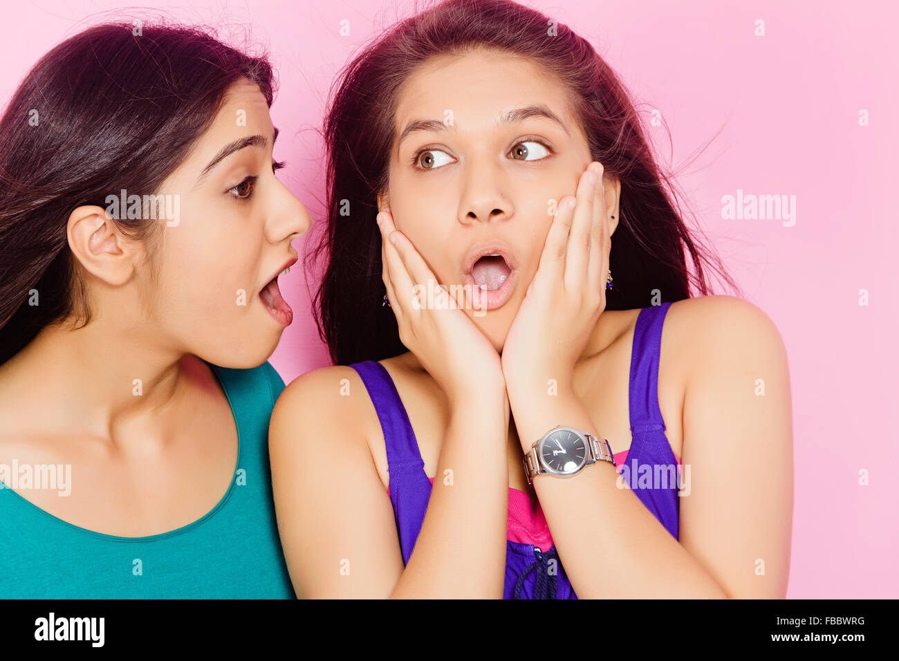 2 indian Young Womans friends  Whisper Talking Stock Photo