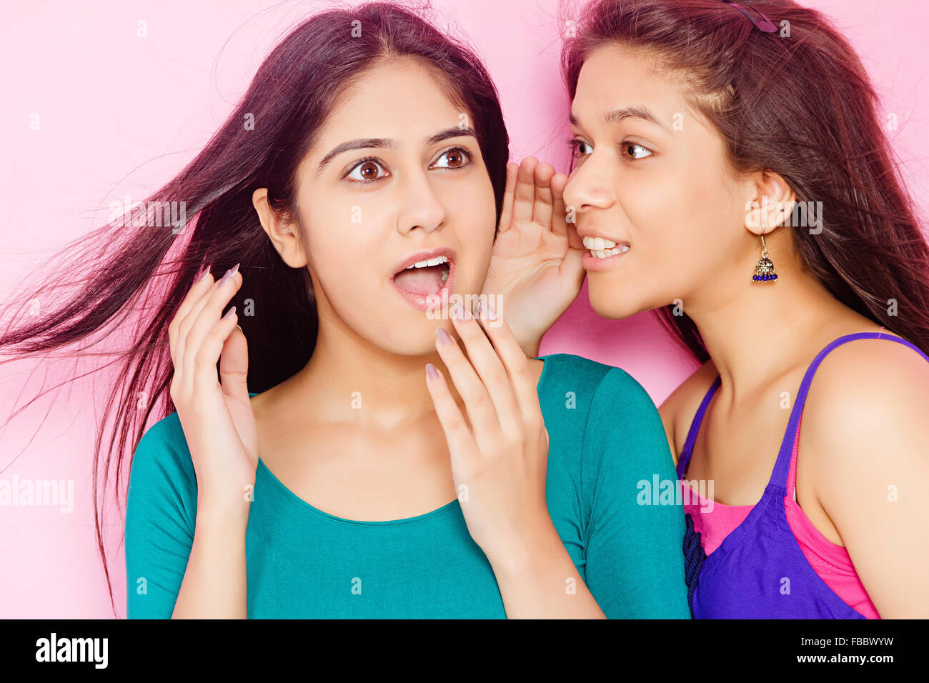2 indian Young Womans friends  Whisper Talking Stock Photo