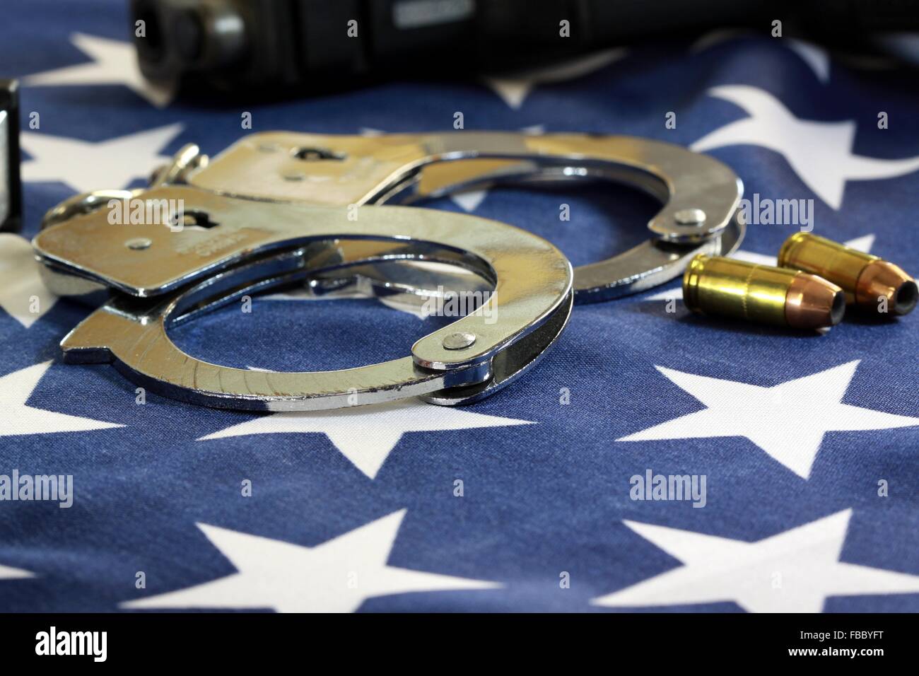Handcuffs and ammunition on United States Flag Stock Photo