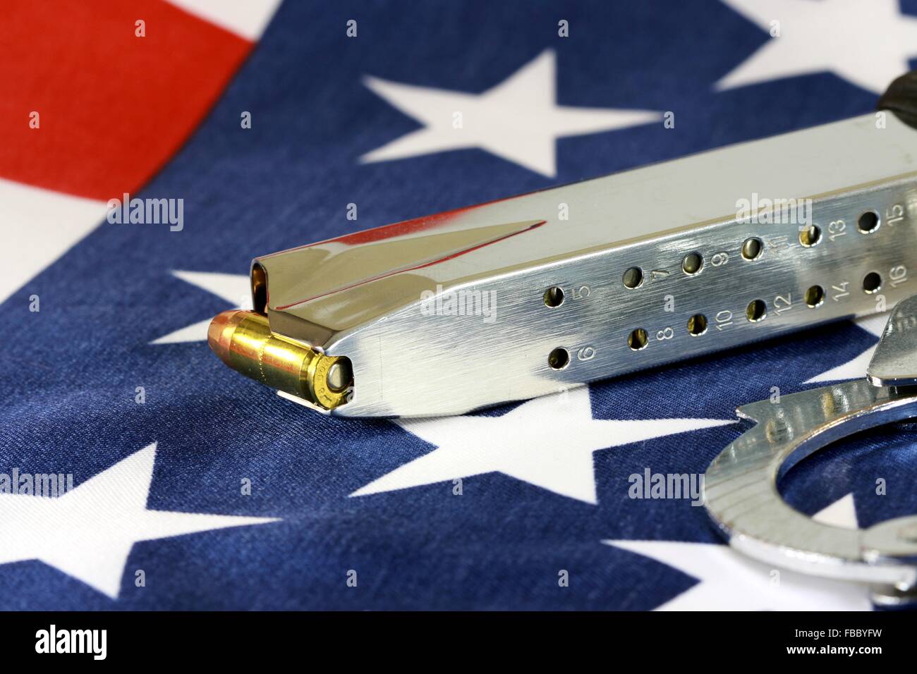Handcuffs and ammunition on United States Flag Stock Photo