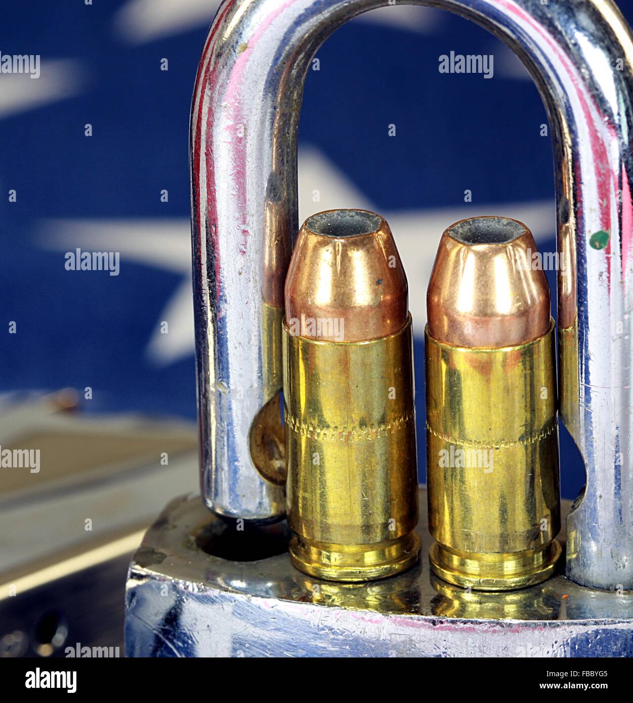 Ammunition and padlock on United States flag - Gun rights and gun control concept Stock Photo