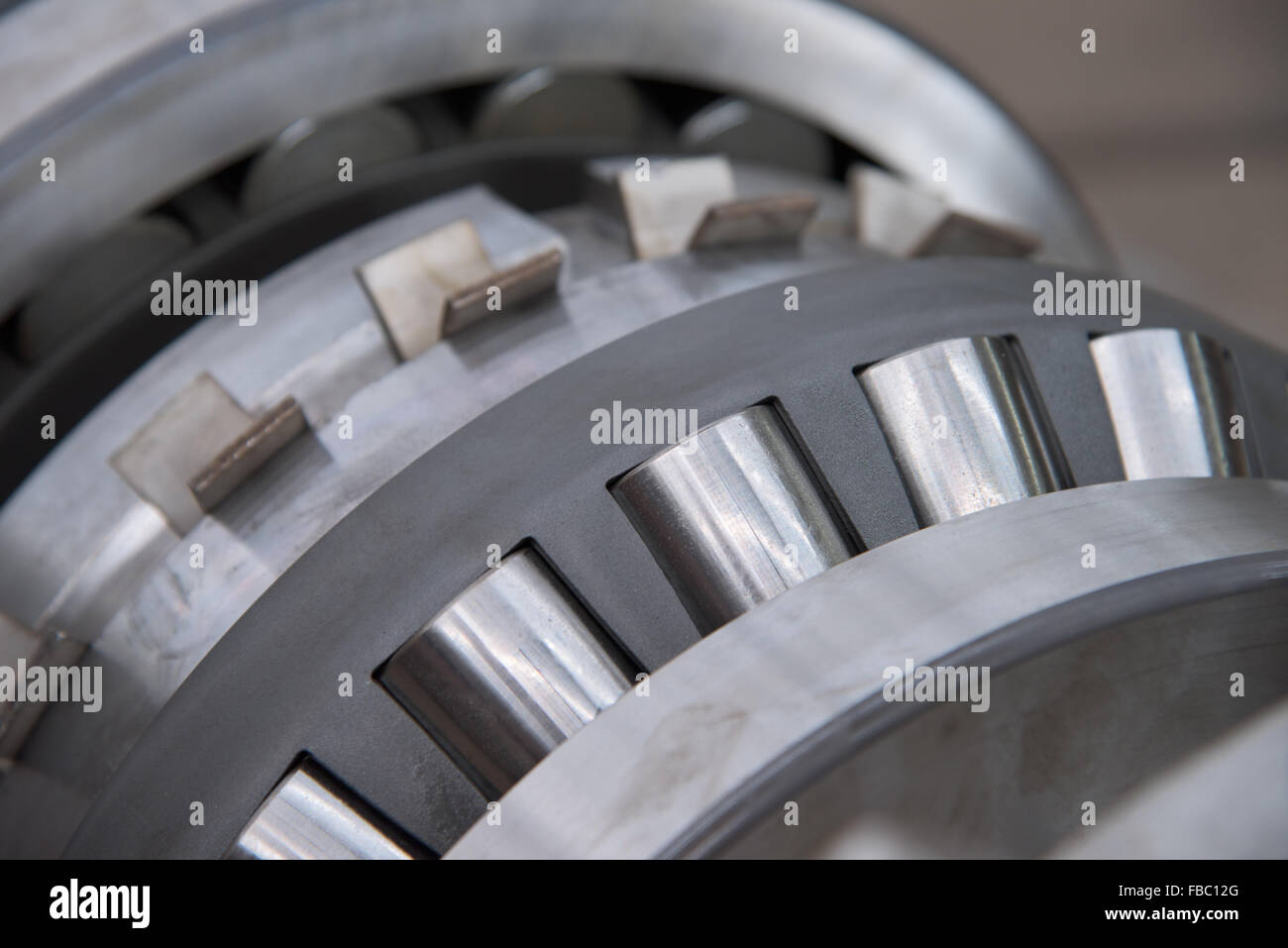Stainless roller bearing on industrial size drive shaft. Shallow depth of field with only parts