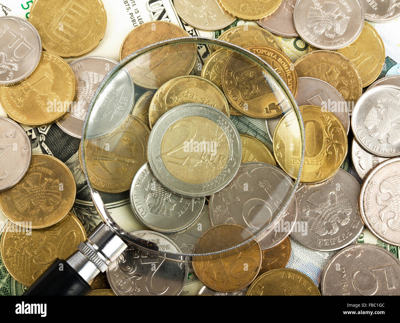 Magnifier on coins Stock Photo Alamy