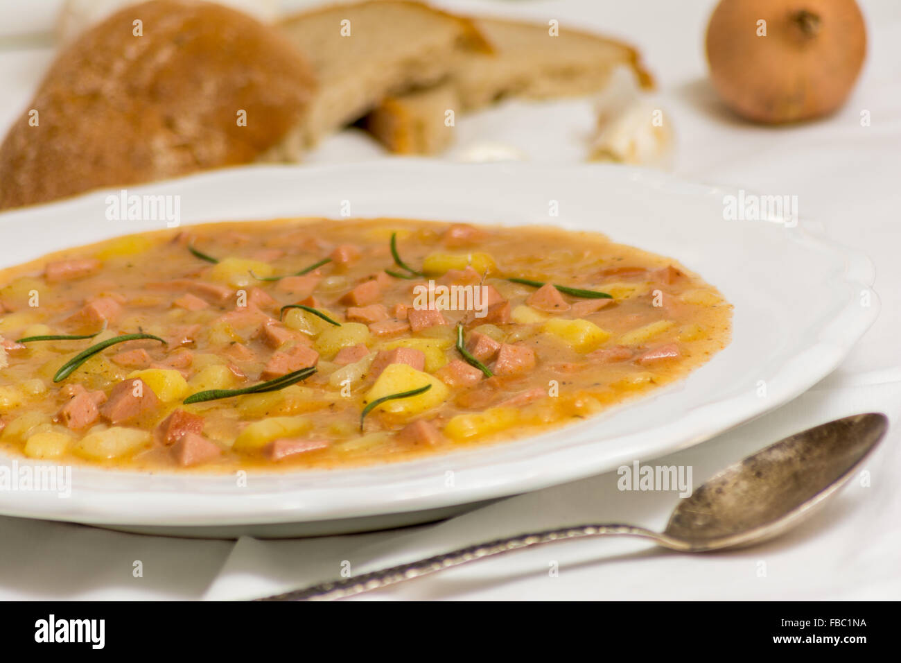 Czech traditional potato goulash with sausage and bread Stock Photo