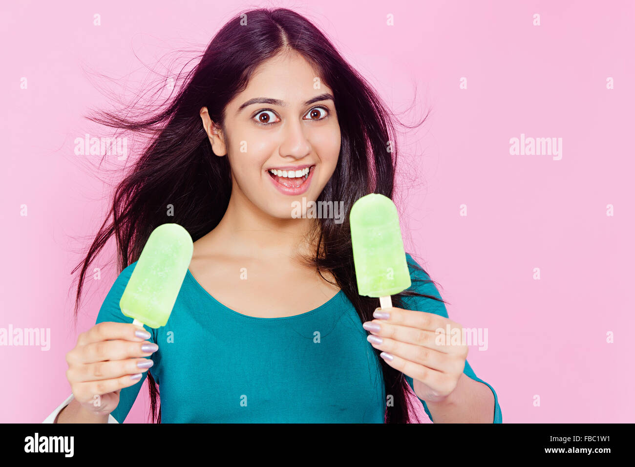 1 indian Young Woman Eating Ice Cream Stock Photo