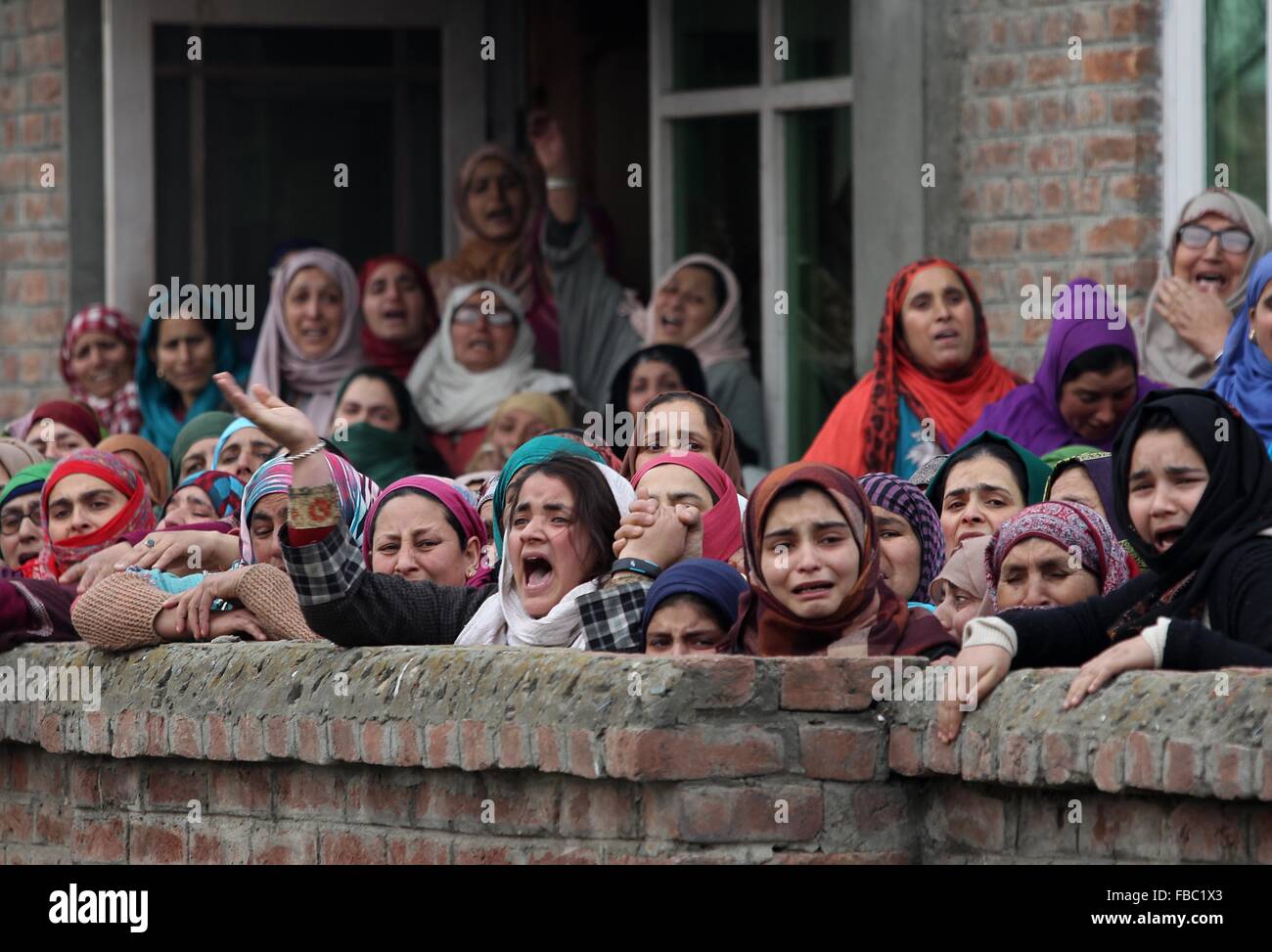 (160114) -- SRINAGAR, Jan. 14, 2016 (Xinhua) -- Kashmiri women wail over the death of Owais Bashir Malik, an engineering student, during his funeral procession in Srinagar, summer capital of Indian-controlled Kashmir, Jan. 14, 2016. Indian police fired warning shots and tear gas shells to disperse hundreds of Kashmiri protesters who had blocked road to Srinagar airport and shouting anti-India slogans after the body of a college student with his throat slit was found in the Indian-controlled Kashmir. The protesters accused the Indian army of torturing and killing the student. However, the army Stock Photo