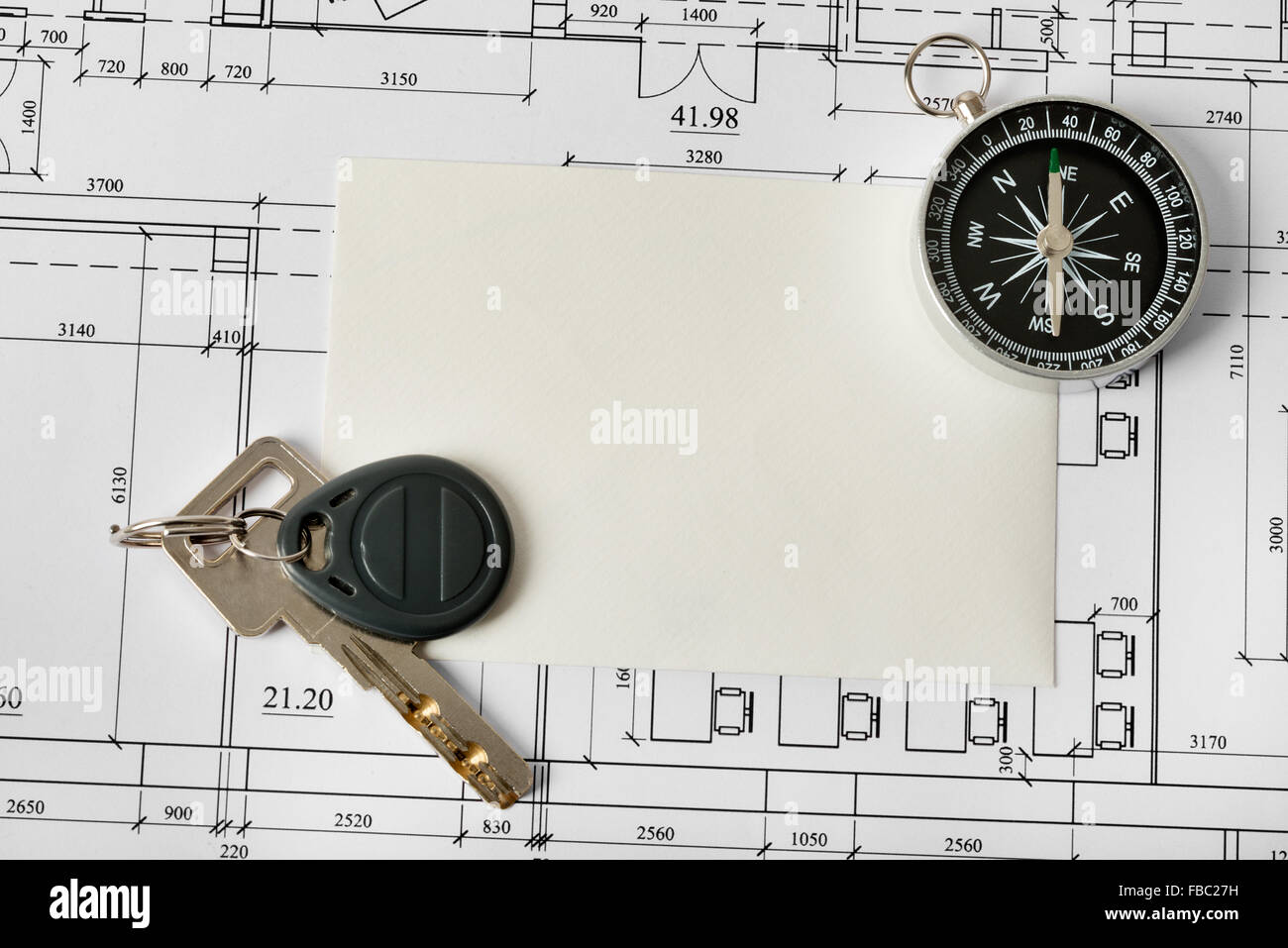 Compass with blueprints and key Stock Photo Alamy