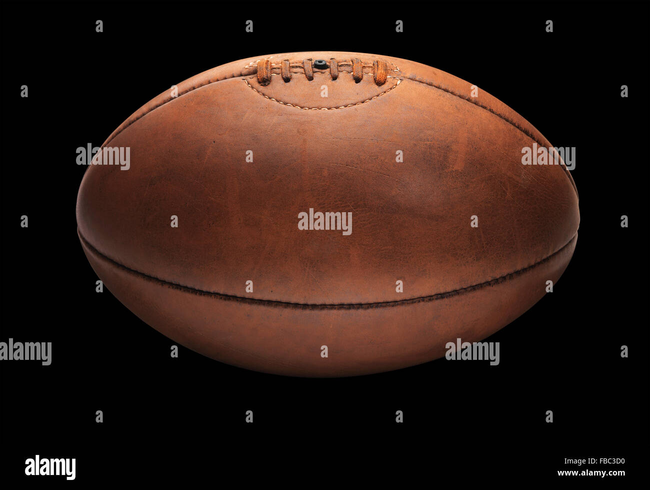Vintage Tan Old Rugby Ball on Black Stock Photo