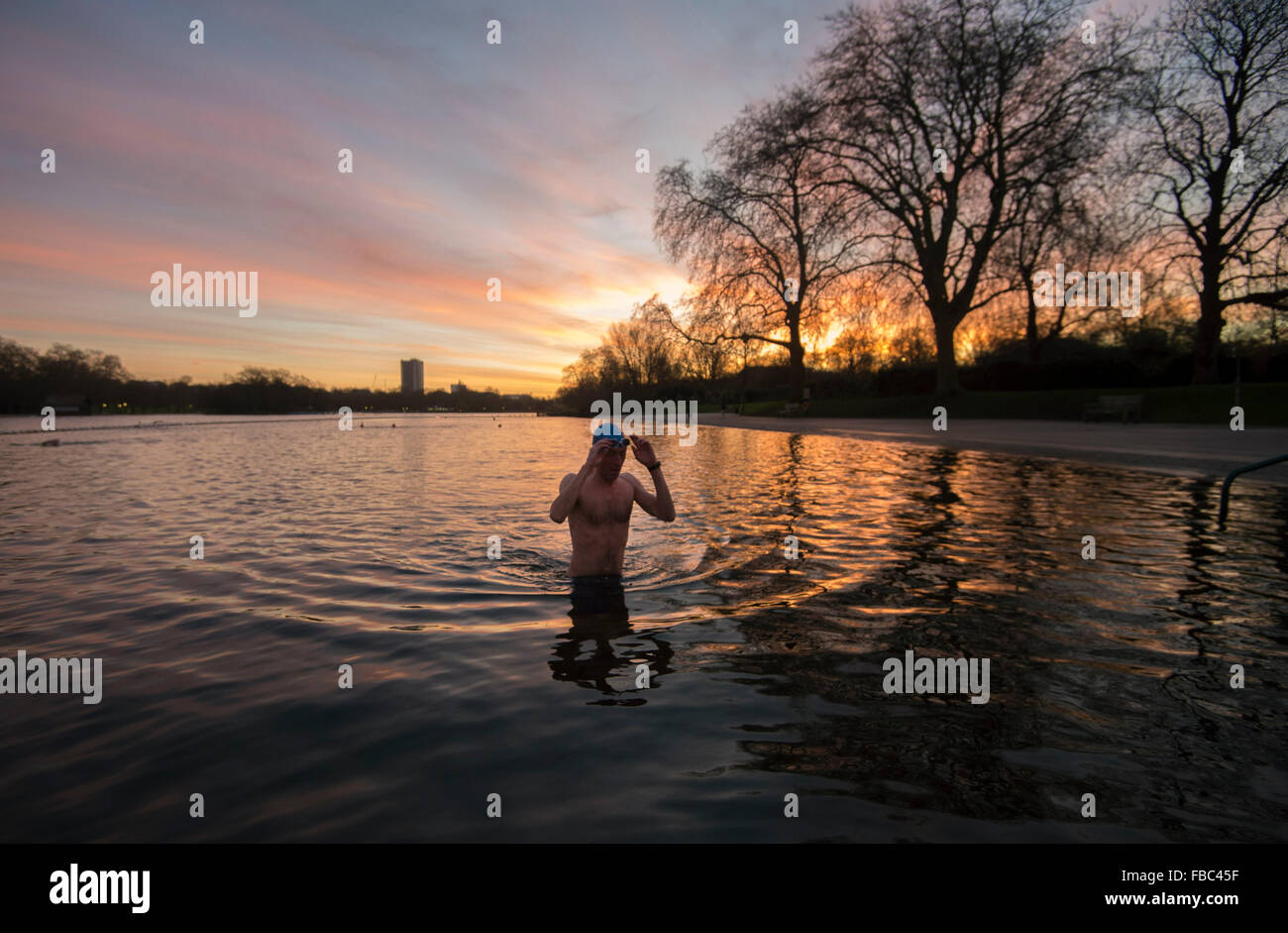 A man takes an early morning swim in the Serpentine, Hyde Park, London