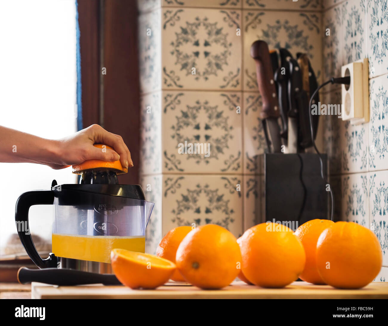 Squeezing orange to extract some healthy juice Stock Photo Alamy