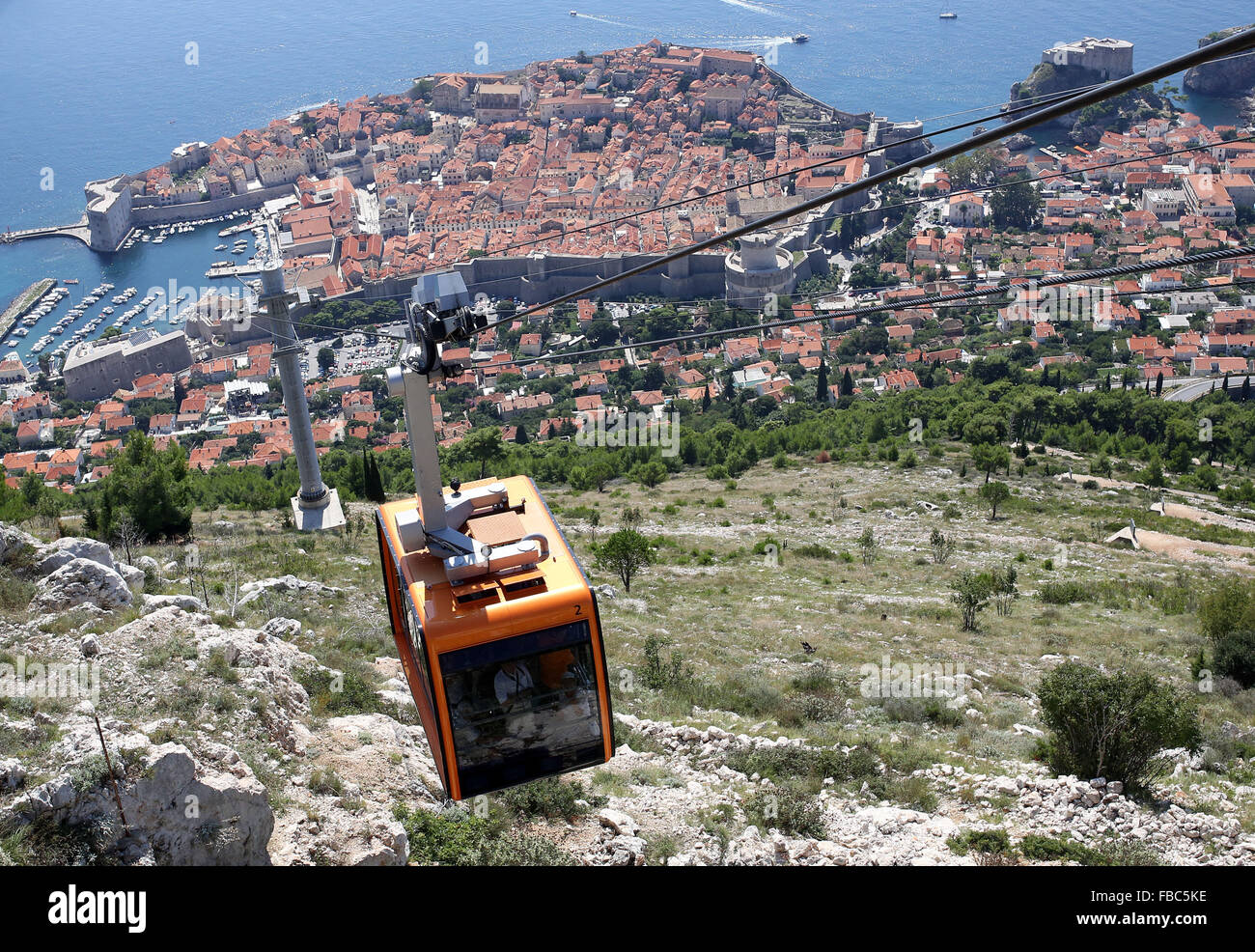 A cable car travels above Dubrovnik old town in Croatia Stock Photo