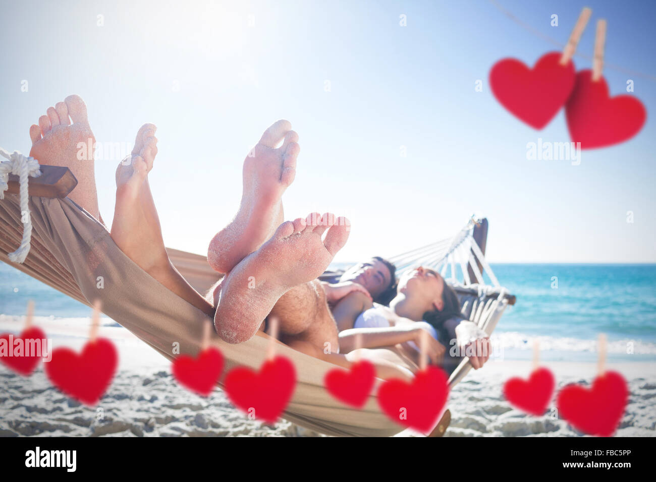Composite image of happy couple napping together in the hammock Stock Photo