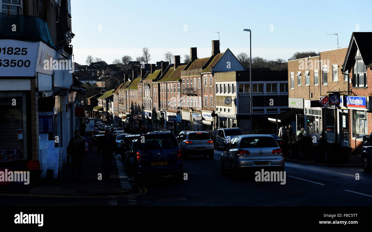 Uckfield East Sussex UK - Traffic drives down the High Street in harsh sunlight on a winter morning Stock Photo