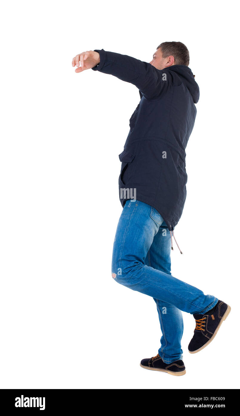 Balancing young man in parka. or dodge the falling man. Rear view people collection. backside view of person. Isolated over white background. The falling man. Stock Photo