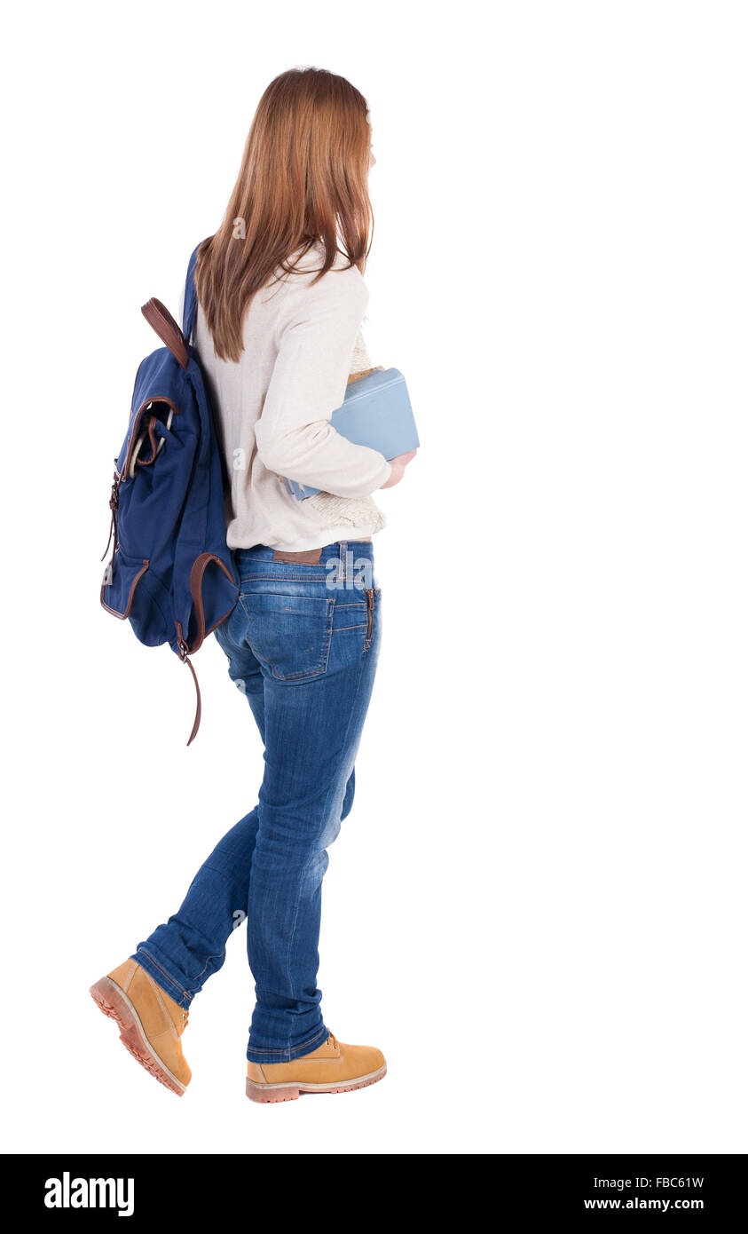 Girl with a backpack on his back is a stack of books. back view. Rear ...