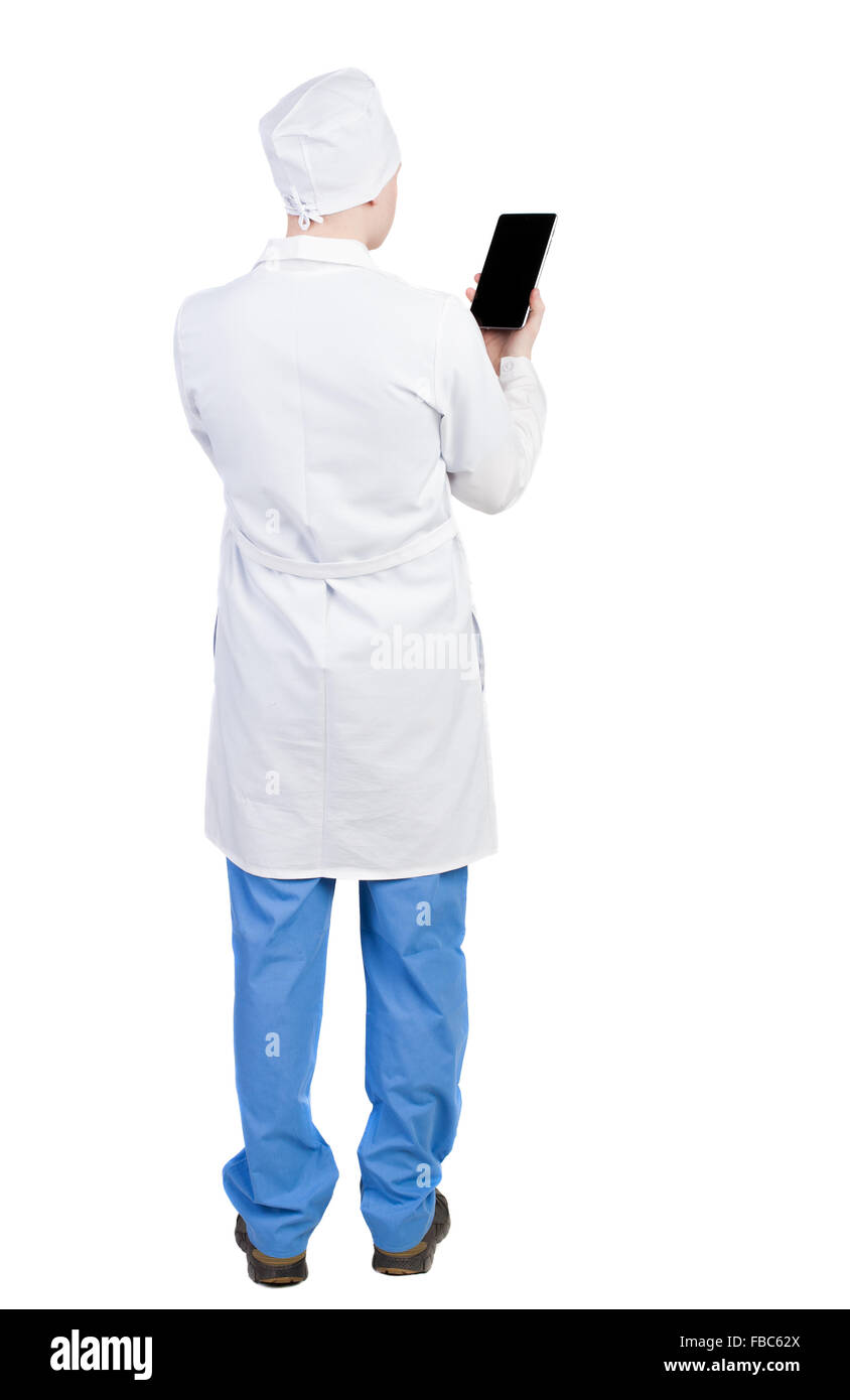 Back view of doctor in robe holding tablet computer. Standing young guy. Rear view people collection.  backside view of person. Stock Photo
