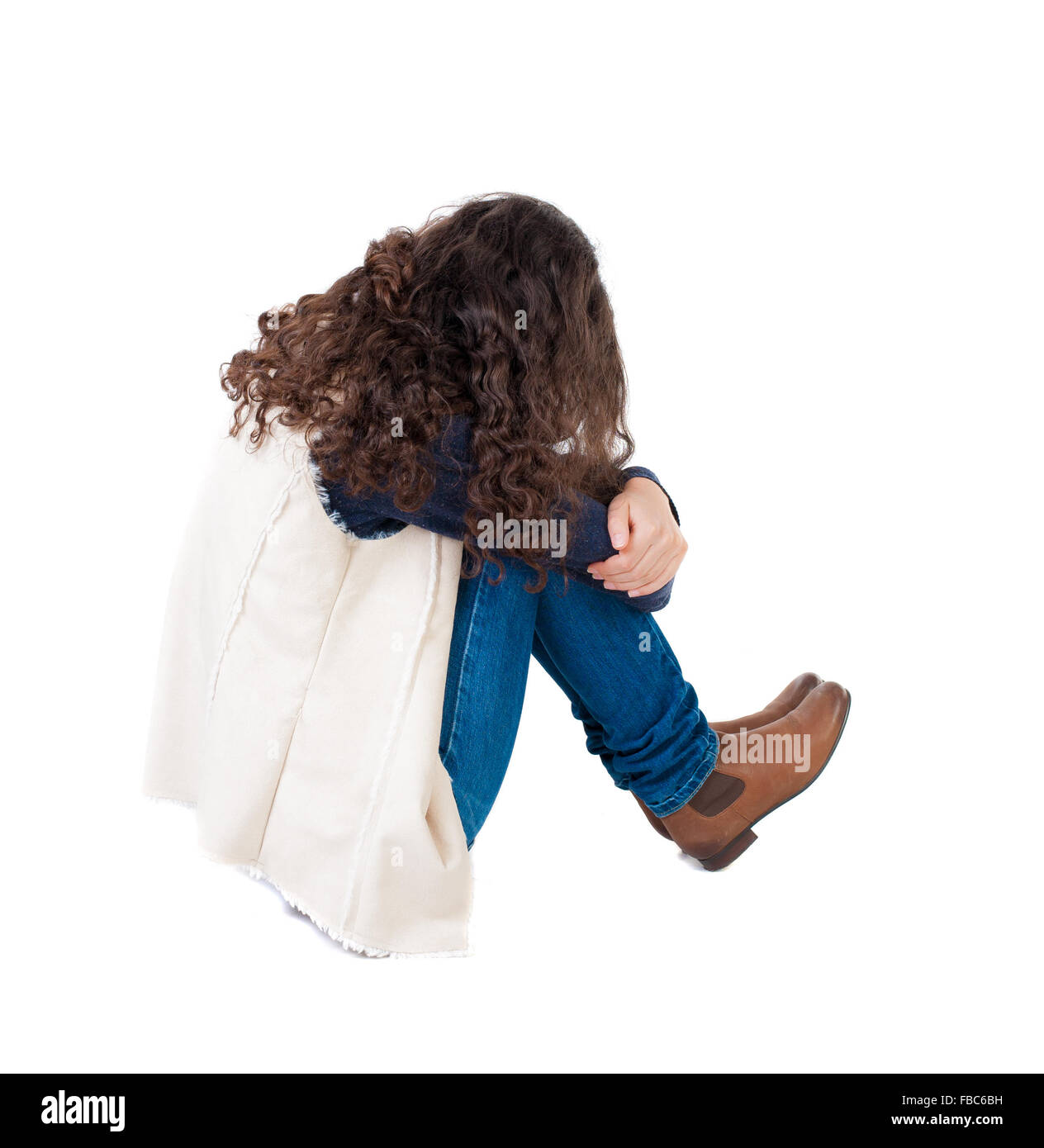 back view curly girl sitting and crying. girl relaxes. Rear view people collection. backside view of person. Isolated over white Stock Photo