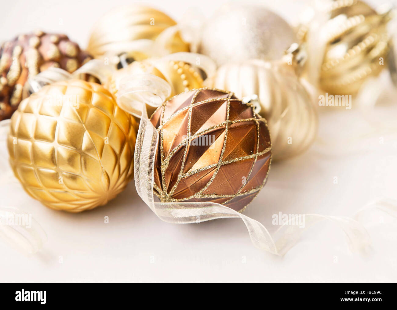 Golden Christmas ornaments with delicate pearl globes and ribbon Stock ...