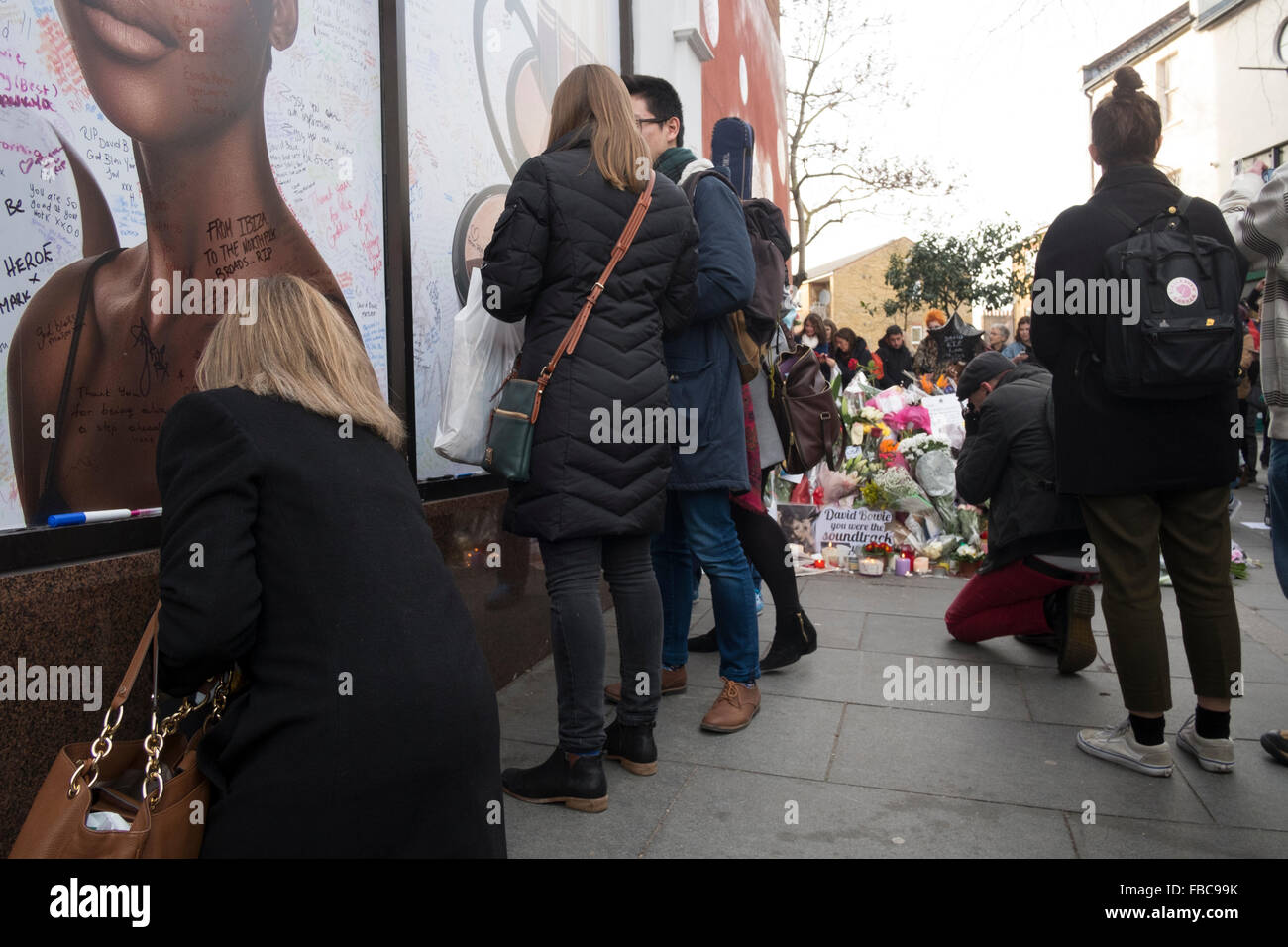 London, UK. 13th Jan, 2016. Fans pay tribute to David Bowie at a mural in Brixton where he was born. Jimmy C Graffiti. David Bowie  died of cancer at the age of 69 on January 10th 2016.  13/01/16 Credit:  claire doherty/Alamy Live News Stock Photo