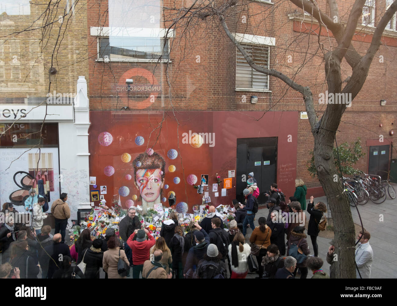 London, UK. 13th Jan, 2016.  Fans pay tribute to David Bowie at a mural in Brixton where he was born. Jimmy C Graffiti. David Bowie  died of cancer at the age of 69 on January 10th 2016.  London,13/01/16 Credit:  claire doherty/Alamy Live News Stock Photo