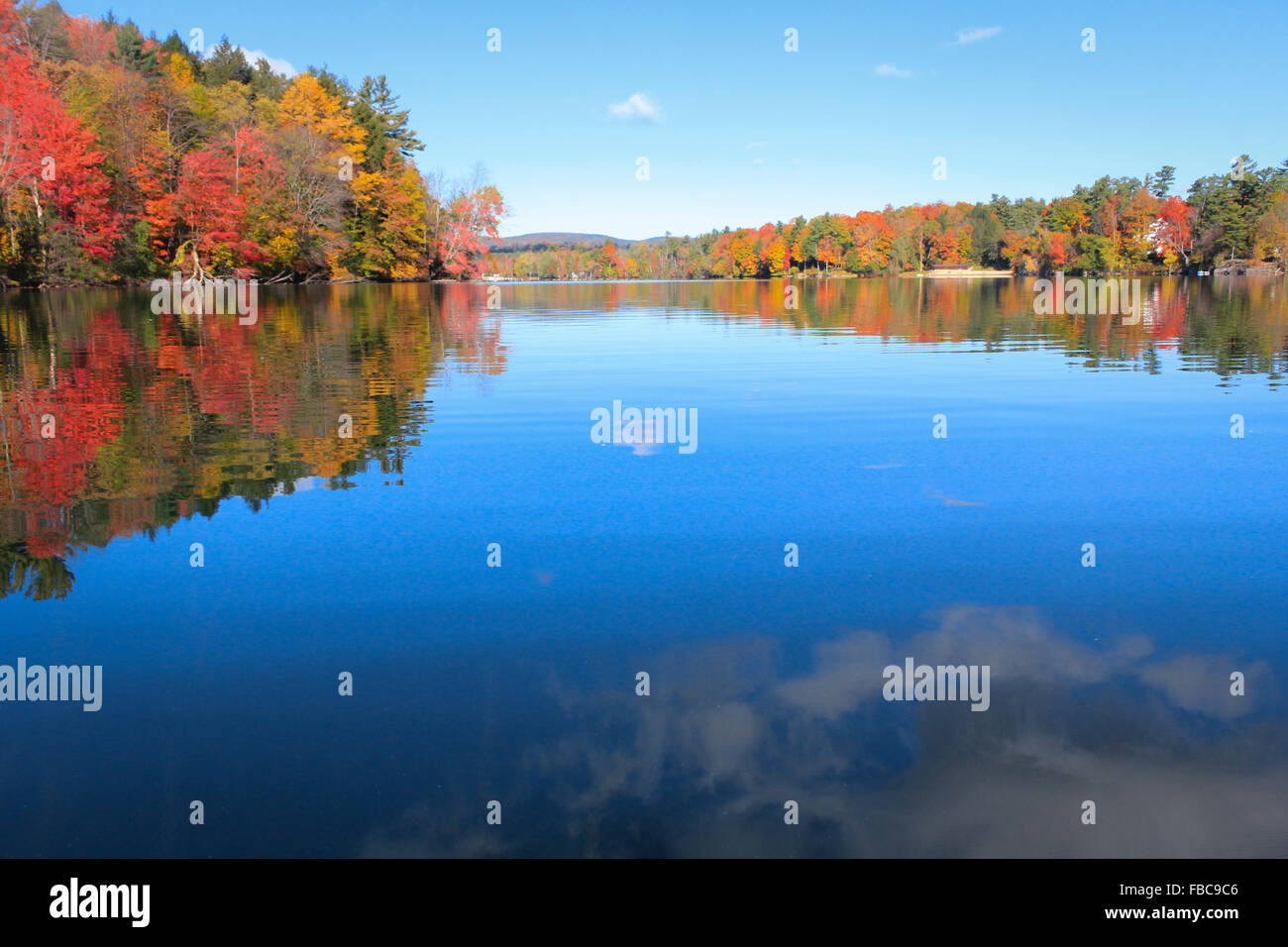Colorful leaves reflected on Lake Laurel. Photographed in Lee, MA in Oct 2014. Stock Photo