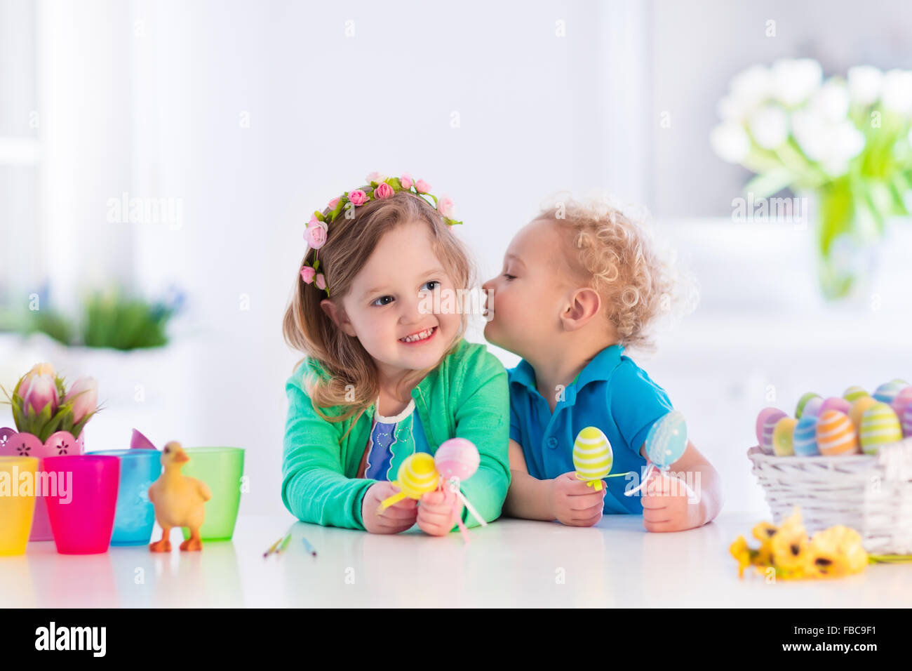 Kids painting colorful eggs. Children paint and decorate Easter egg