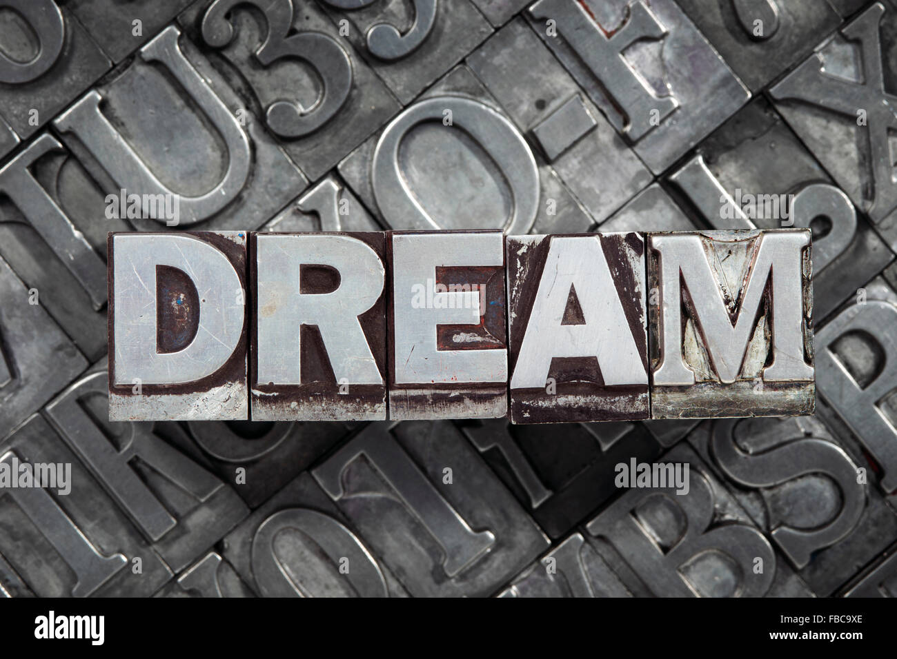 dream word concept made from metallic letterpress blocks on many letters background Stock Photo