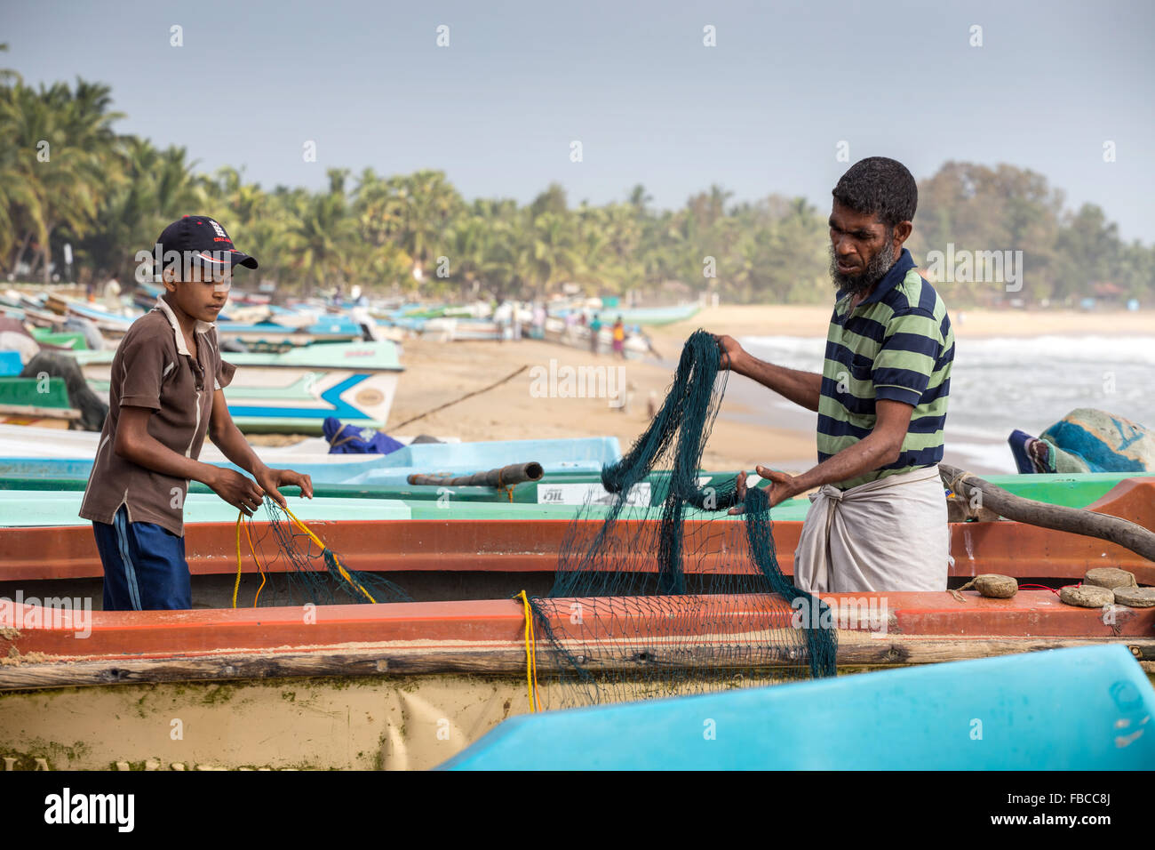 Fishermen, father and son on a beach, Arugam Bay, Sri Lanka, Asia Stock Photo