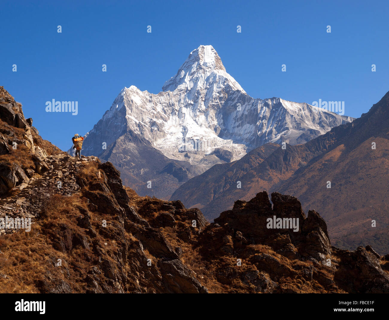 Sherpa and view towards Ama Dablam, Khumbu Valley Stock Photo