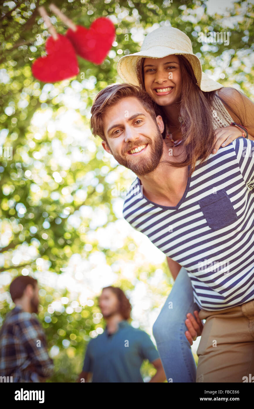 Composite image of hipster couple having fun together Stock Photo