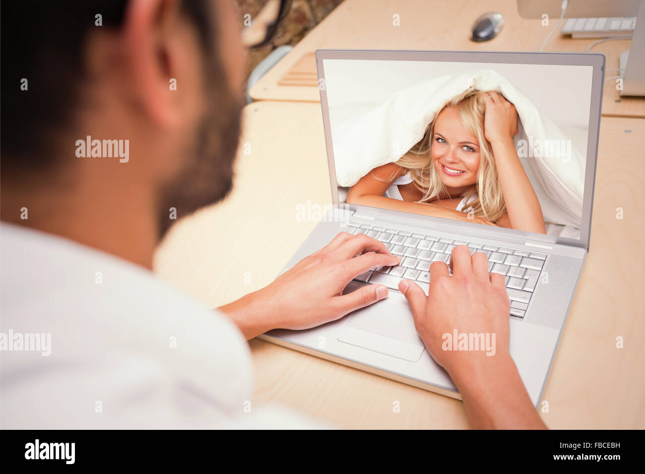 Composite image of smiling woman under a duvet Stock Photo