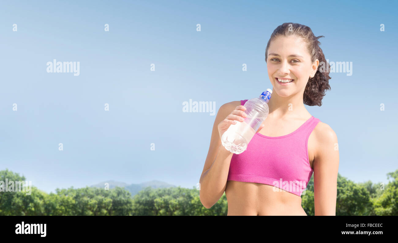 Composite image of fit woman with water Stock Photo