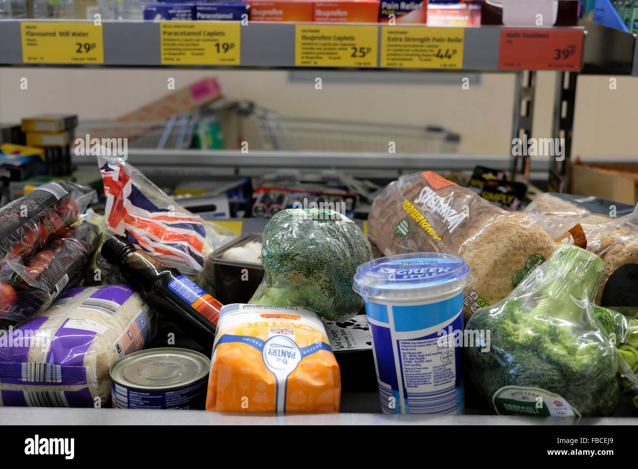 Aldi Supermarket food products groceries on checkout counter at grocery