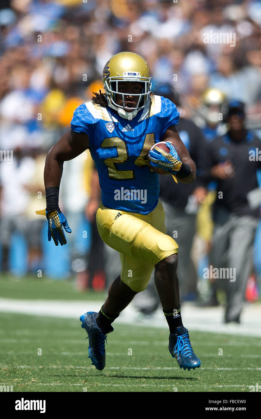 Running back Paul Perkins #24 of the UCLA Bruins rushes up field against the Virginia Cavaliers during the first quarter at the Stock Photo