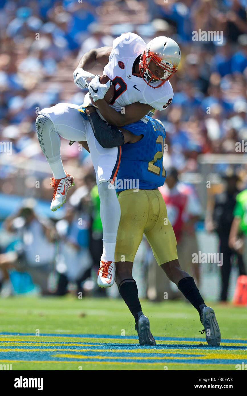 Wide receiver Canaan Severin #9 of the Virginia Cavaliers catches a pass over defensive back Tahaan Goodman #21 of the UCLA Stock Photo