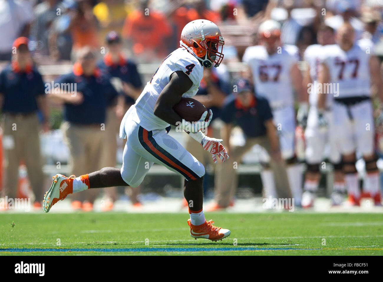 Running back Taquan Mizzell #4 of the Virginia Cavaliers rushes up field against the UCLA Bruins during the first quarter at Stock Photo