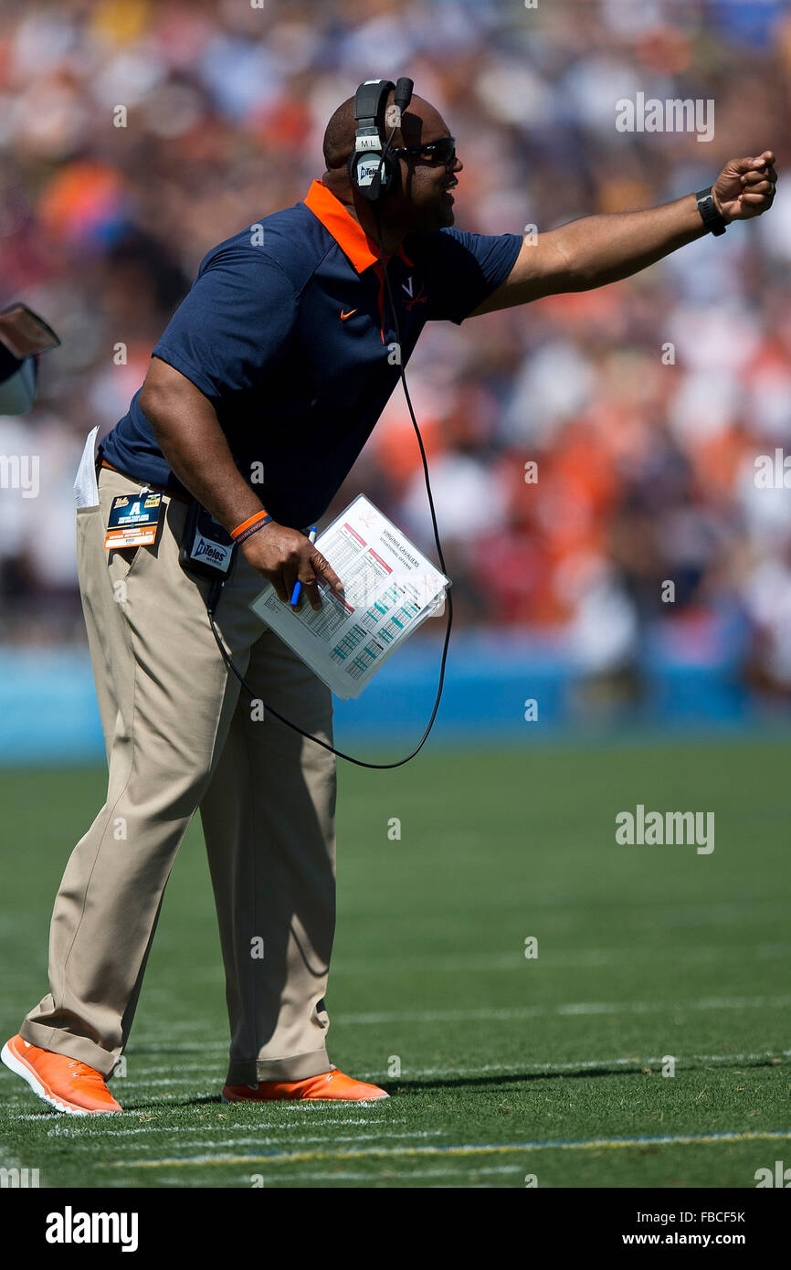 Head coach Mike London of the Virginia Cavaliers stands on the field during the second quarter against the UCLA Bruins at the Stock Photo