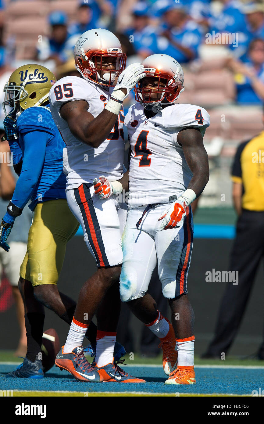 Running back Taquan Mizzell #4 of the Virginia Cavaliers is congratulated by wide receiver Keeon Johnson #85 after scoring a Stock Photo