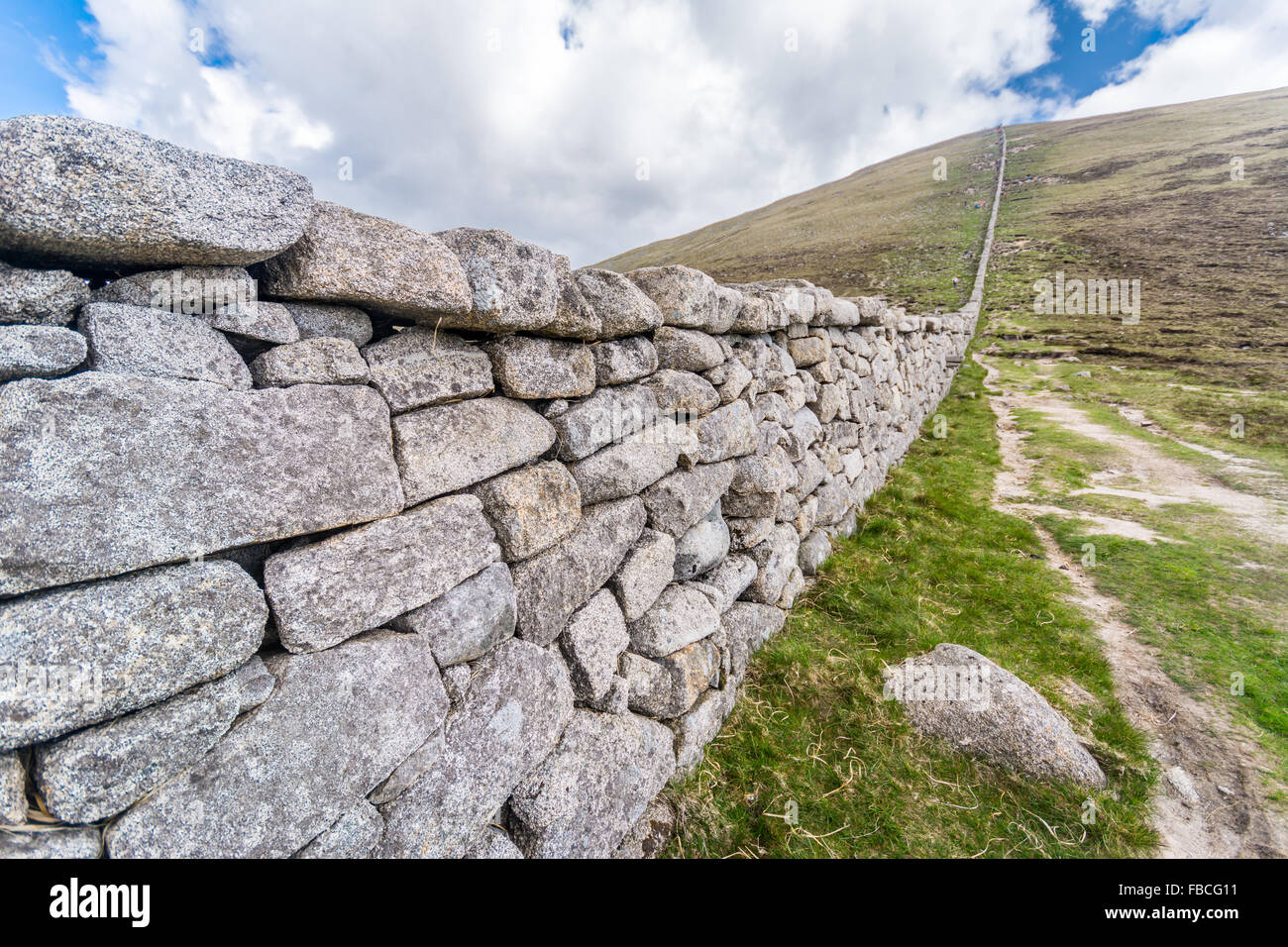The Mourne Mountains wall running up Slieve Donard near Newcastle in County Down, Ireland Stock Photo