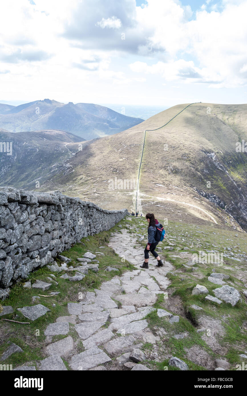 A hill walker descends Slieve Donard in the Mourne Mountain range in County Down, Ireland. Stock Photo