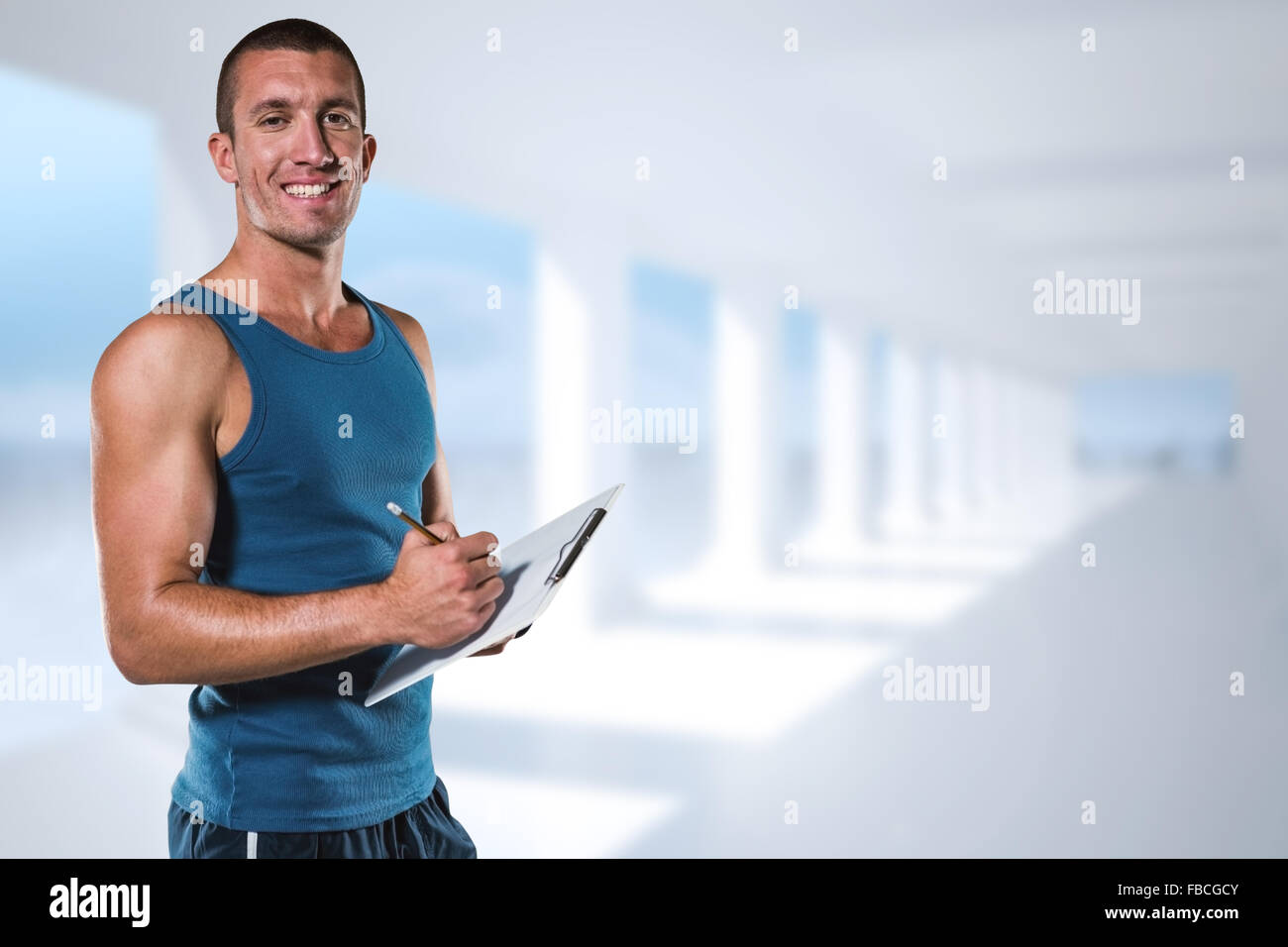 Composite image of portrait of confident sports coach writing on clipboard Stock Photo