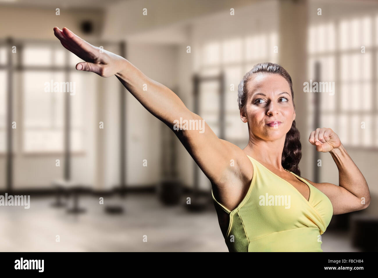 Composite image of beautiful confident athlete stretching hands Stock Photo