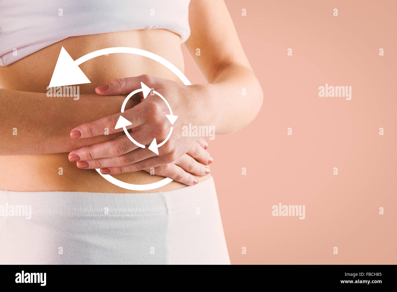 Composite image of slim woman touching her belly Stock Photo