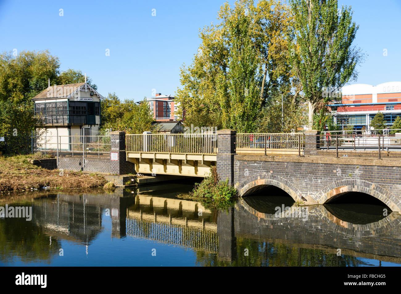 Railway bridge crossing the River Witham in Lincoln with East Holmes disused signalbox in the background Stock Photo