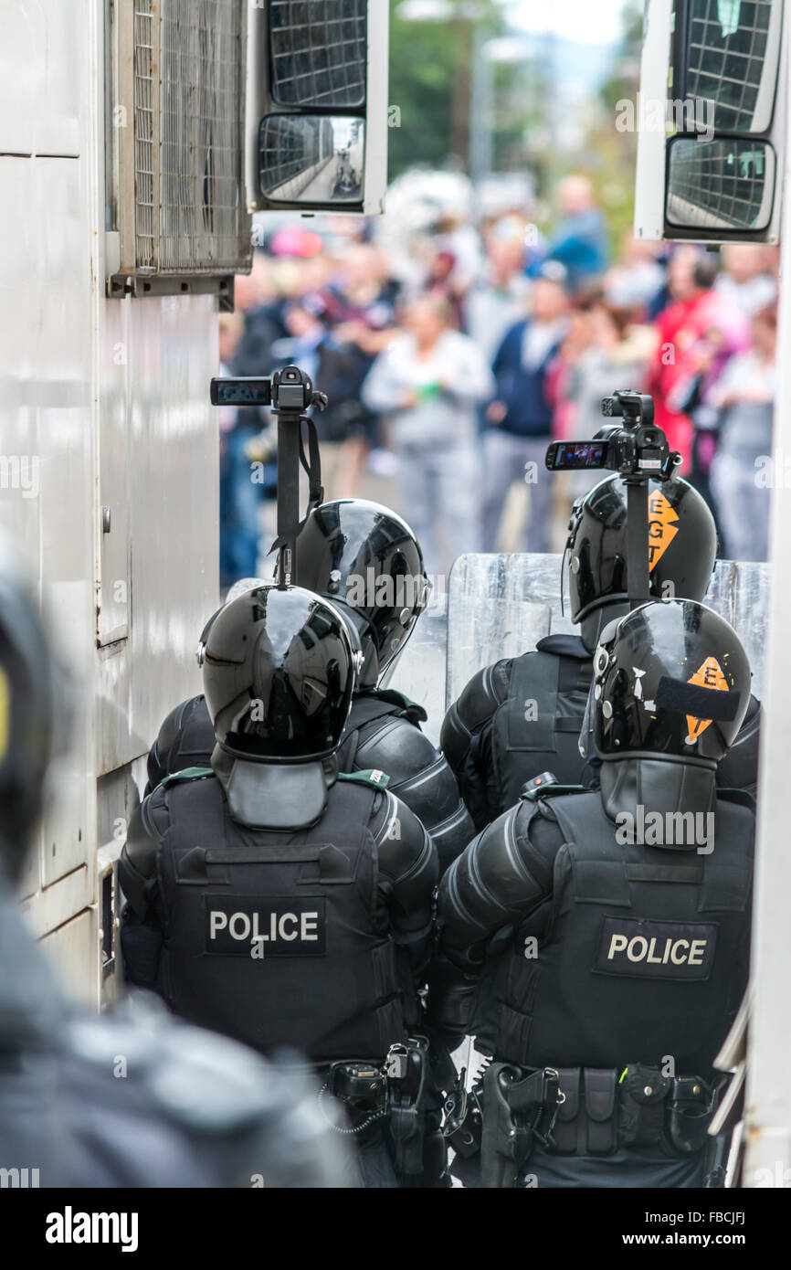 PSNI riot officers gather intelligence during Belfast riot. Stock Photo
