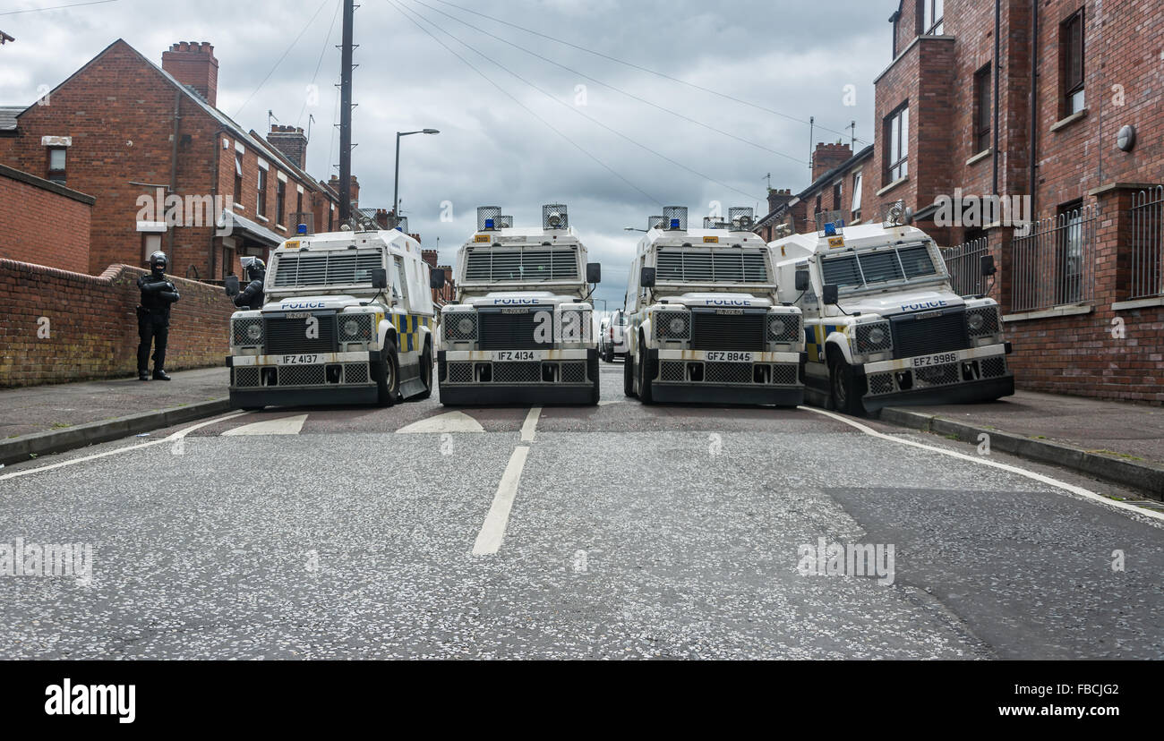 PSNI land rovers block North Belfast street during trouble. Stock Photo