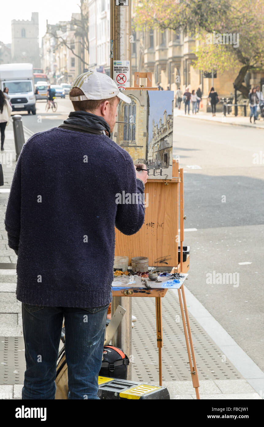 An artist painting Plein Air in High Street, Oxford, England, United Kingdom. Stock Photo