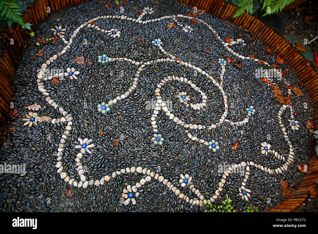 Unique mosaic of stones in a domestic garden in London England Stock Photo
