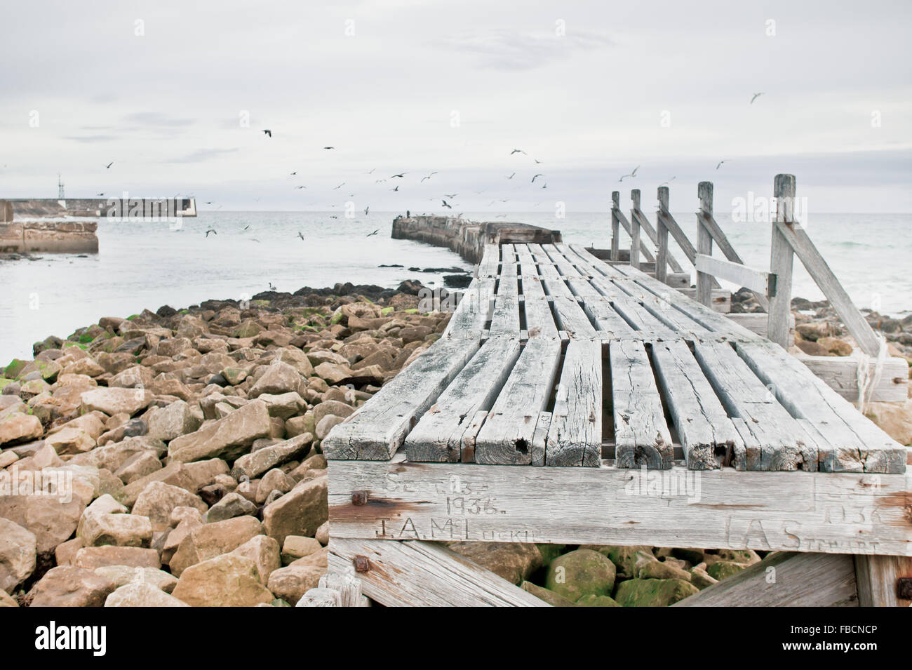 An old wooden walkway at the coast in Scotland, which is incomplete Stock Photo
